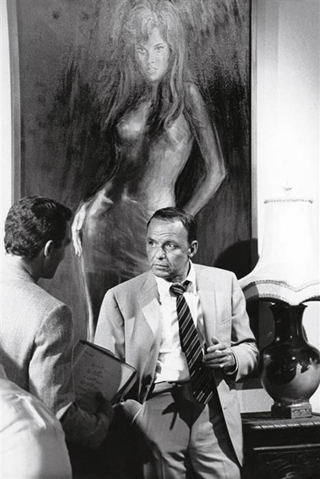 Frank Sinatra, 1968 Miami beneath a portrait of Raquel Welch